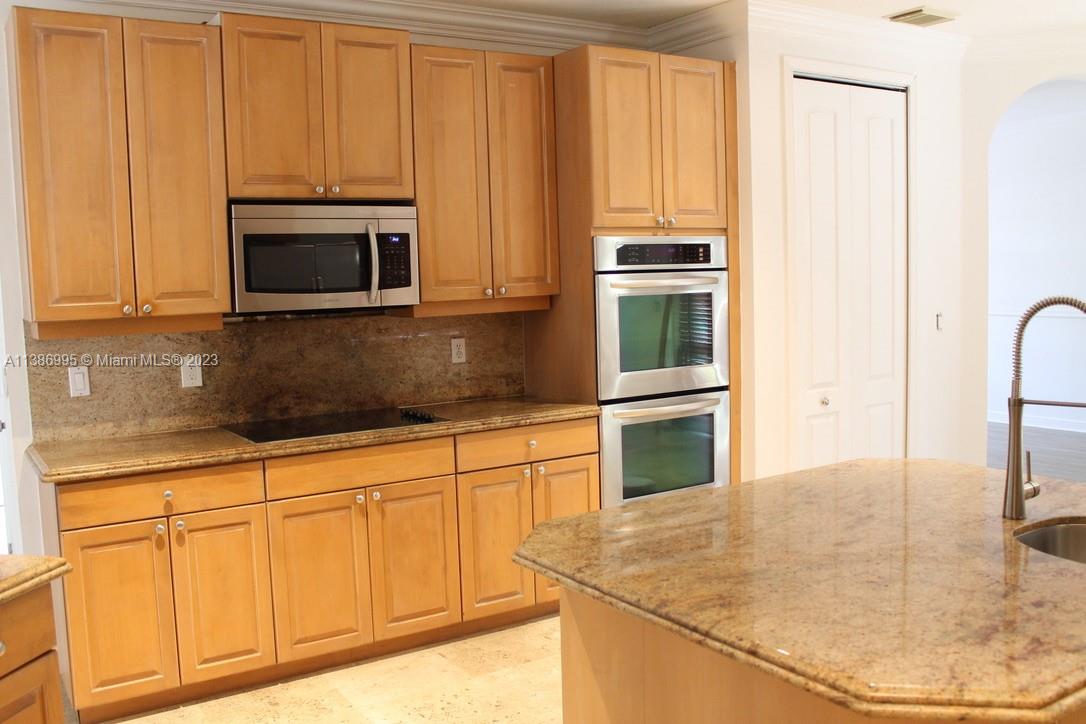 Windsor Palms Miramar, FL 33027 - Photo 10 of 30 a kitchen with granite countertop white cabinets and stainless steel appliances