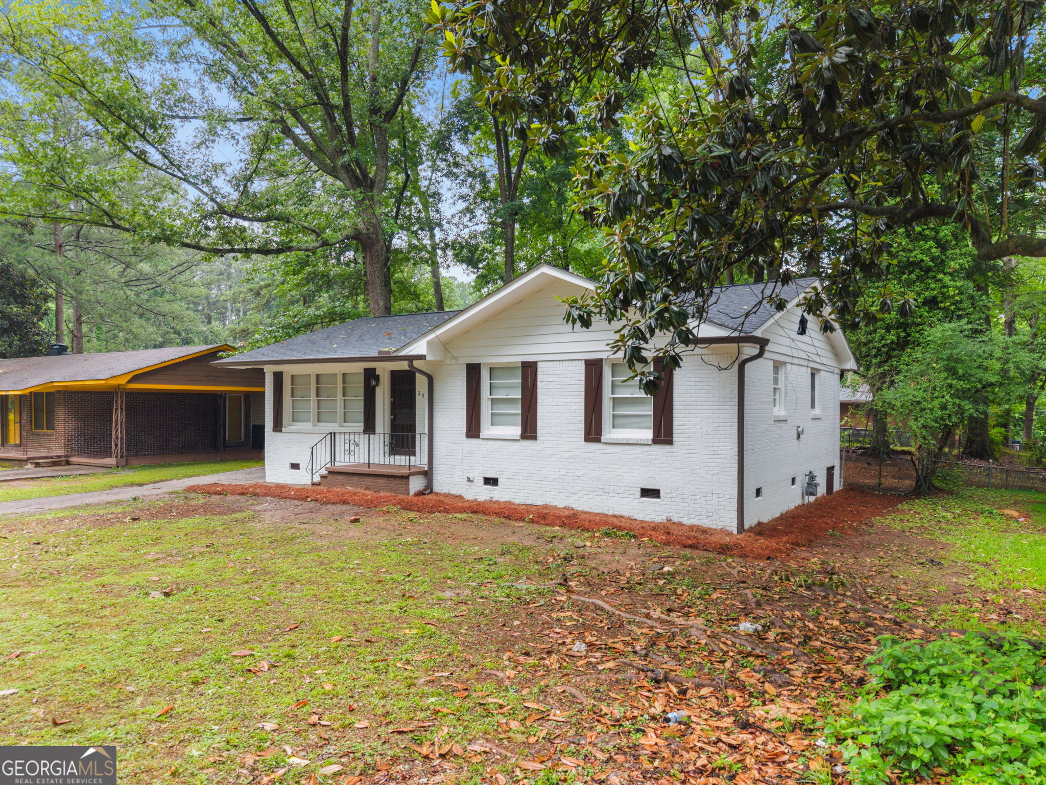 3567 Forrest Park Road Southeast Atlanta, GA 30354 - Photo 3 of 29 a front view of a house with a yard and trees