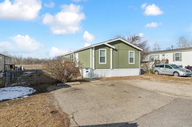 a front view of a house with a garden and patio