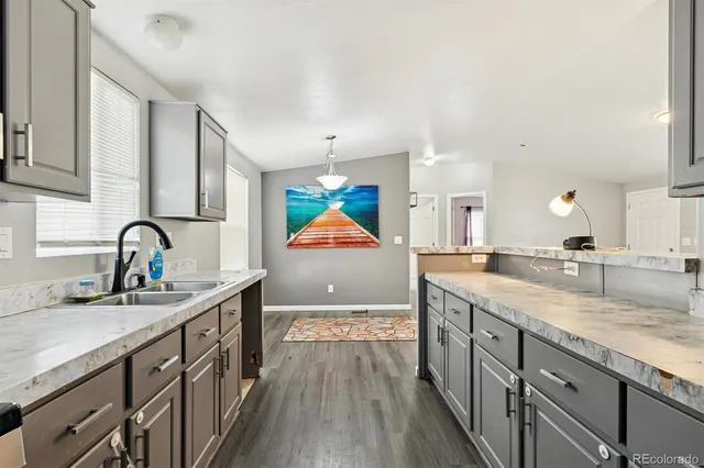 a kitchen with stainless steel appliances granite countertop a sink and a stove top oven