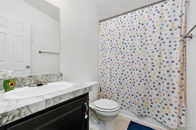 a bathroom with a sink toilet and a mirror