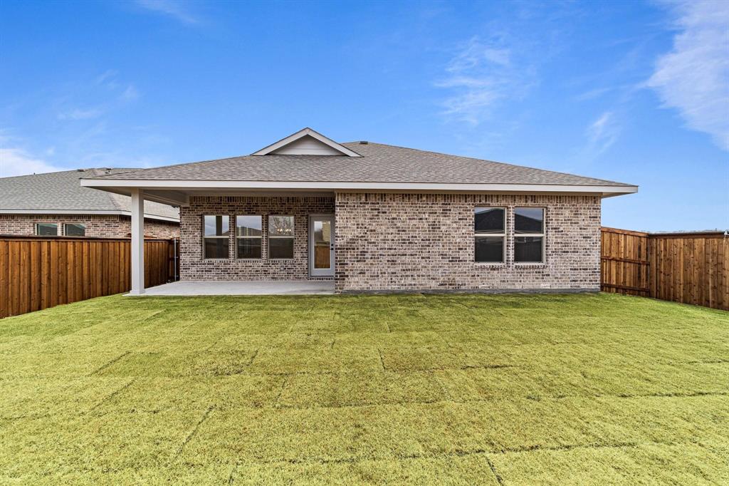 1509 Hamilton Street Howe, TX 75459 - Photo 23 of 23 Back of house with brick siding, a fenced backyard, a shingled roof, and a patio area