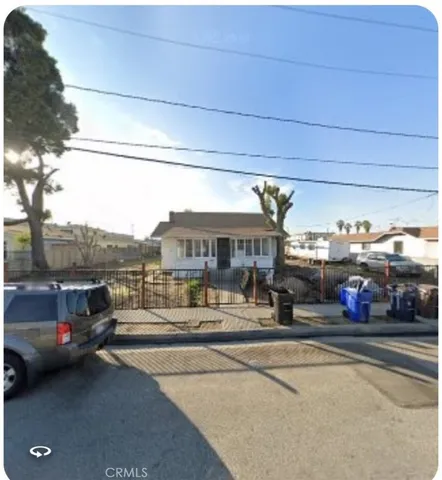 a view of a city street with a car parked on the road