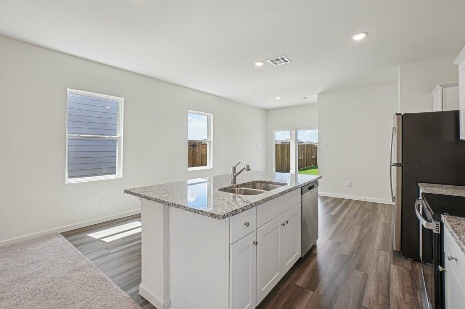 9356 Beryl Lane Conroe, TX 77303 - Photo 2 of 10 a kitchen with a sink appliances and cabinets