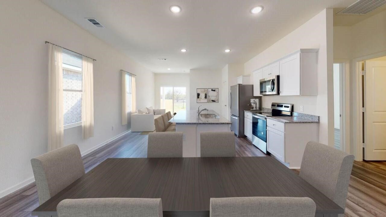 9356 Beryl Lane Conroe, TX 77303 - Photo 4 of 10 a living room with furniture wooden floor and a fireplace