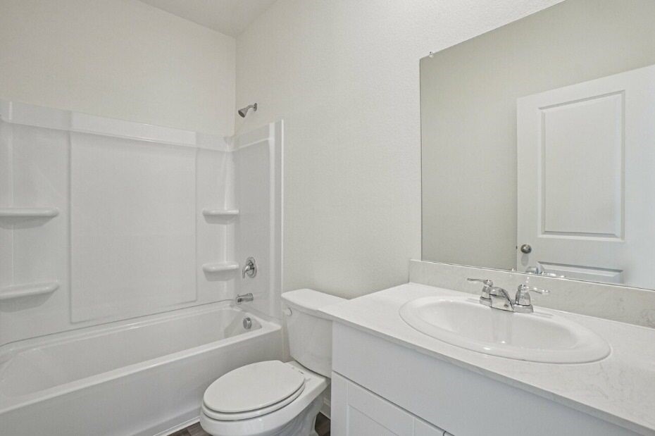 9356 Beryl Lane Conroe, TX 77303 - Photo 8 of 10 a bathroom with a toilet a sink and a bathtub