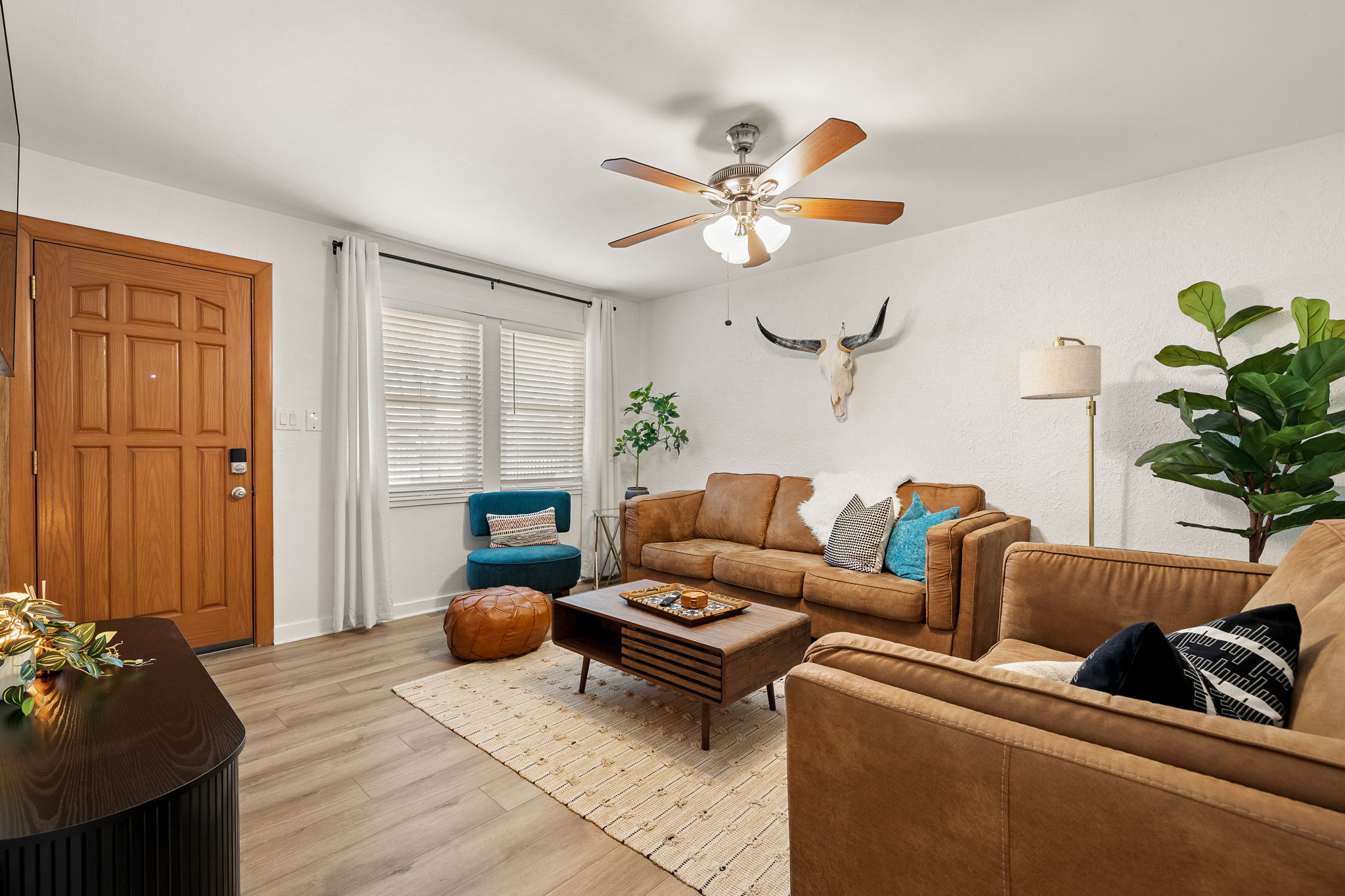 a living room with furniture and a chandelier