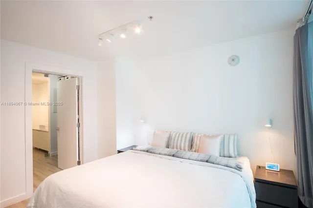 a bedroom with a bed and a table