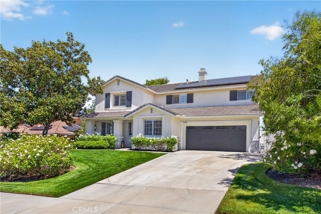 31928 Cercle Chambertin Temecula, CA 92591 - Photo 63 of 74 a front view of a house with a garden and yard
