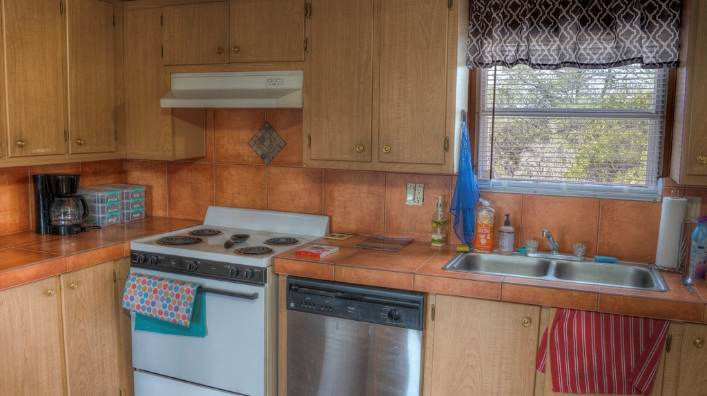 560 Pine Mountain Road Camp Wood, TX 78833 - Photo 12 of 38 a kitchen with stainless steel appliances granite countertop a sink stove and cabinets