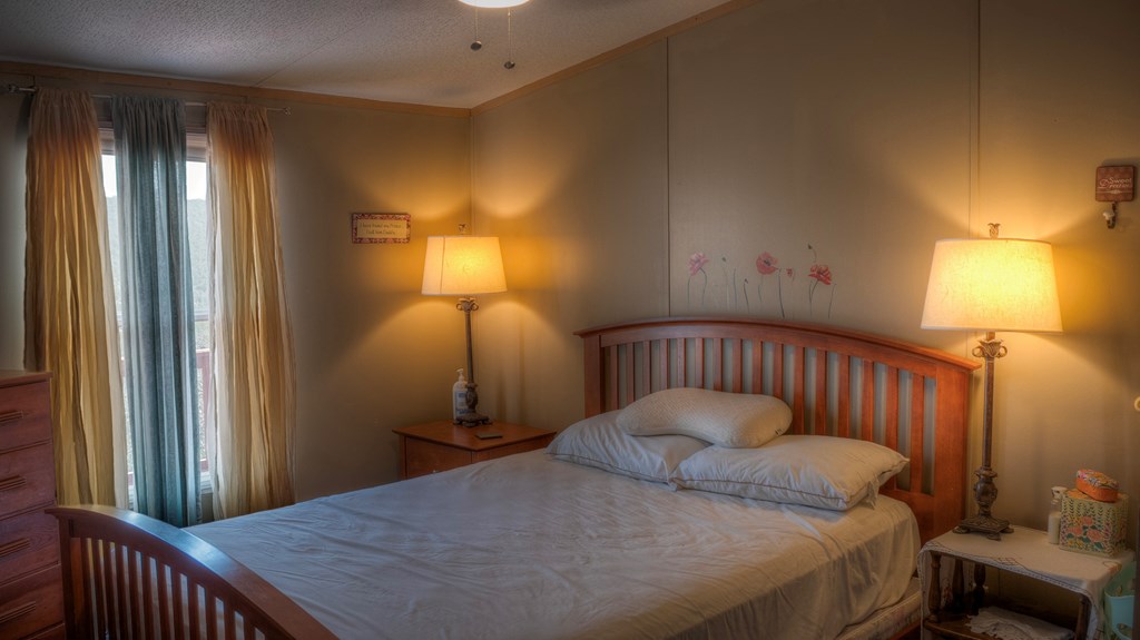560 Pine Mountain Road Camp Wood, TX 78833 - Photo 18 of 38 a bedroom with a bed and a lamp