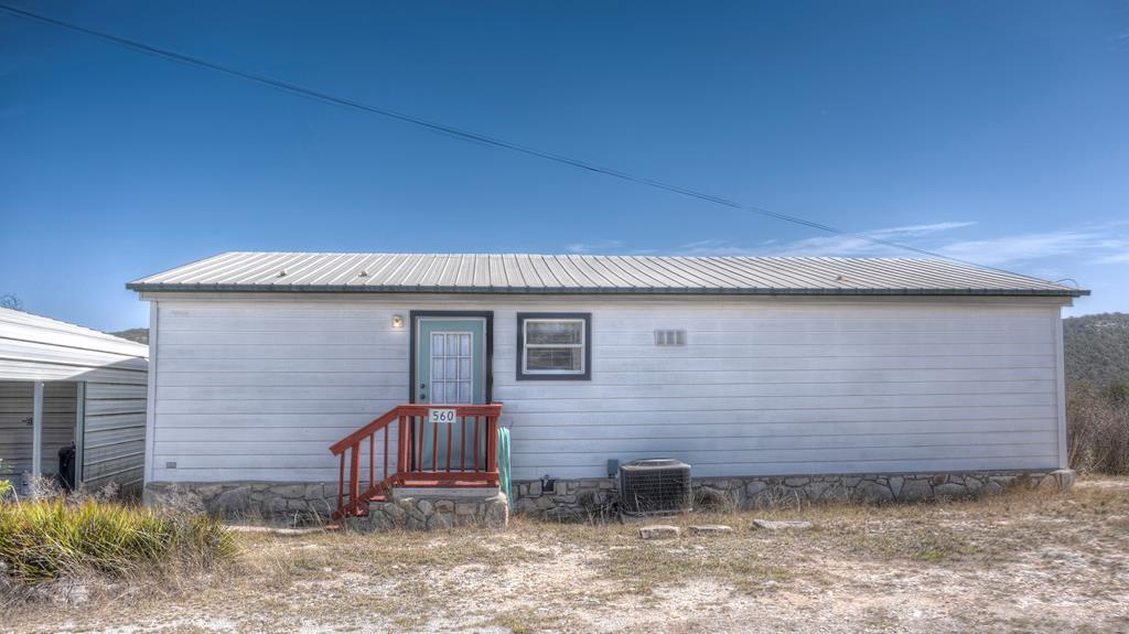 560 Pine Mountain Road Camp Wood, TX 78833 - Photo 2 of 38 a front view of a house with garden