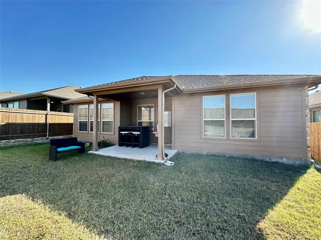 a view of a house with a backyard