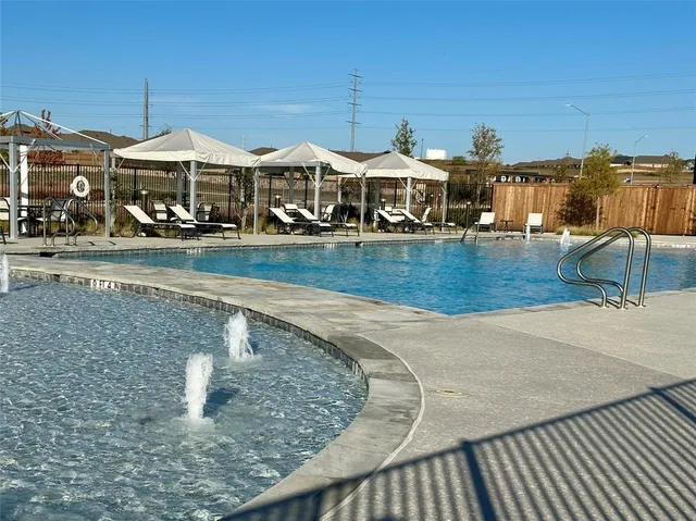 a view of a house with pool and chairs