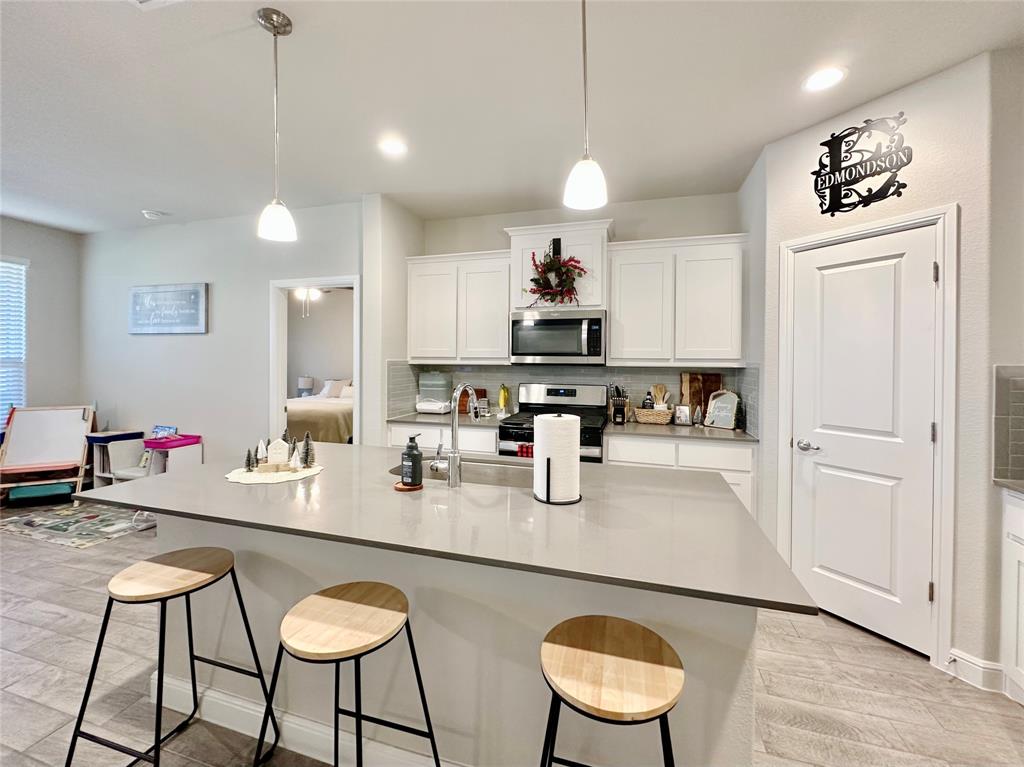 149 Attwater Road Rhome, TX 76078 - Photo 8 of 28 a kitchen with stainless steel appliances granite countertop a sink and a refrigerator
