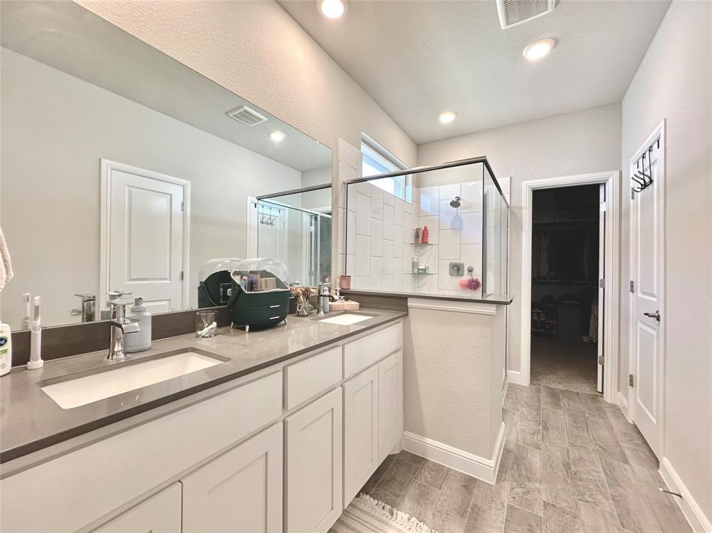 149 Attwater Road Rhome, TX 76078 - Photo 10 of 28 a bathroom with a double vanity sink and mirror