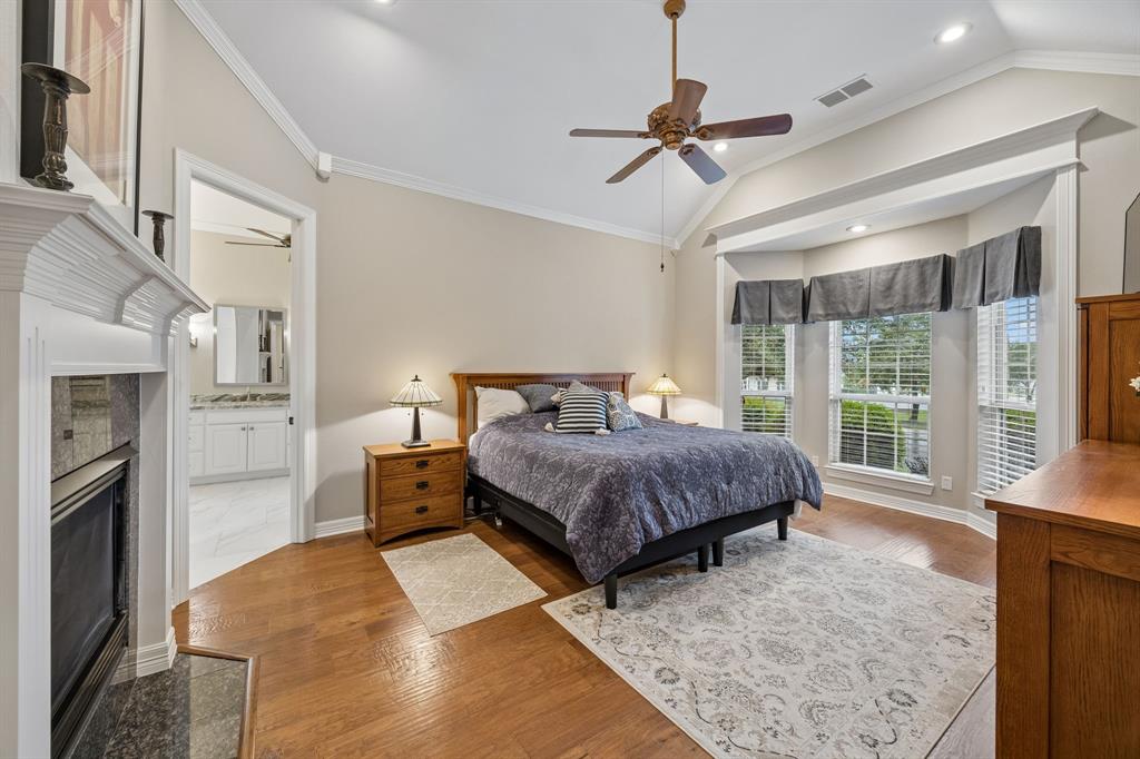 2930 Falcon Way Midlothian, TX 76065 - Photo 17 of 40 a bedroom with a large bed and a chandelier fan