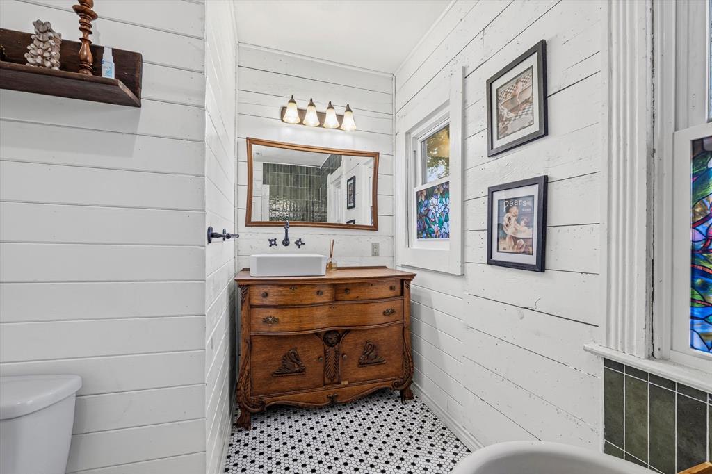 1618 North 6th Street Waco, TX 76707 - Photo 15 of 36 a bathroom with a sink a toilet and mirror
