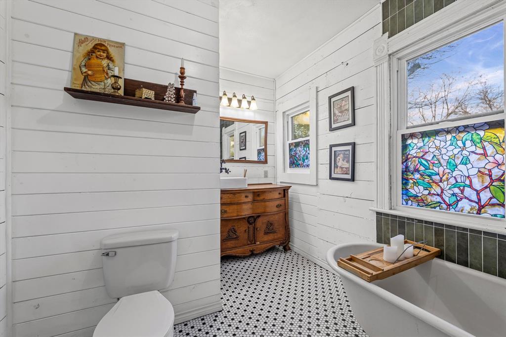 1618 North 6th Street Waco, TX 76707 - Photo 16 of 36 a bathroom with a toilet and a shower