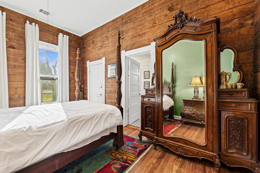 1618 North 6th Street Waco, TX 76707 - Photo 17 of 36 a bedroom with a bed and wooden floor