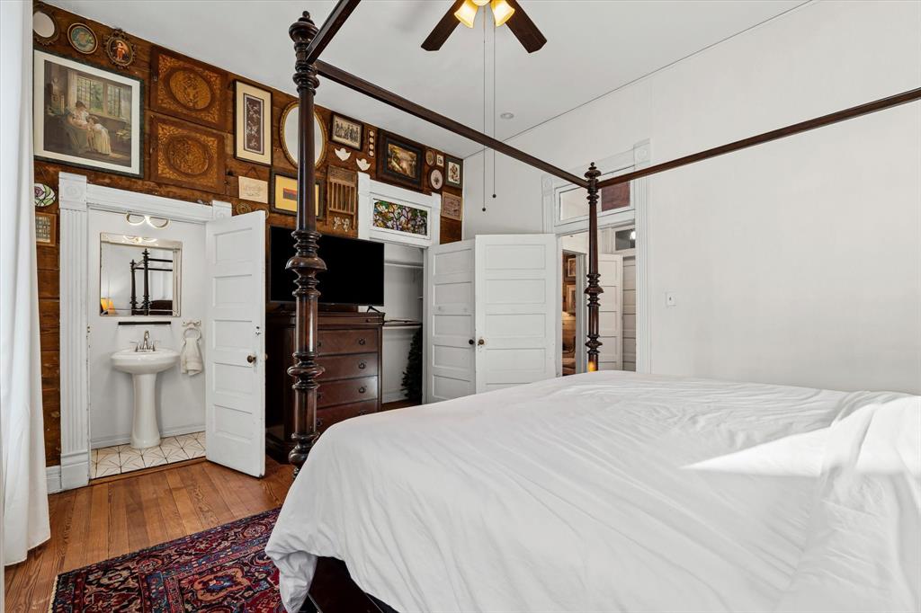 1618 North 6th Street Waco, TX 76707 - Photo 21 of 36 a bedroom with a bed and a chandelier