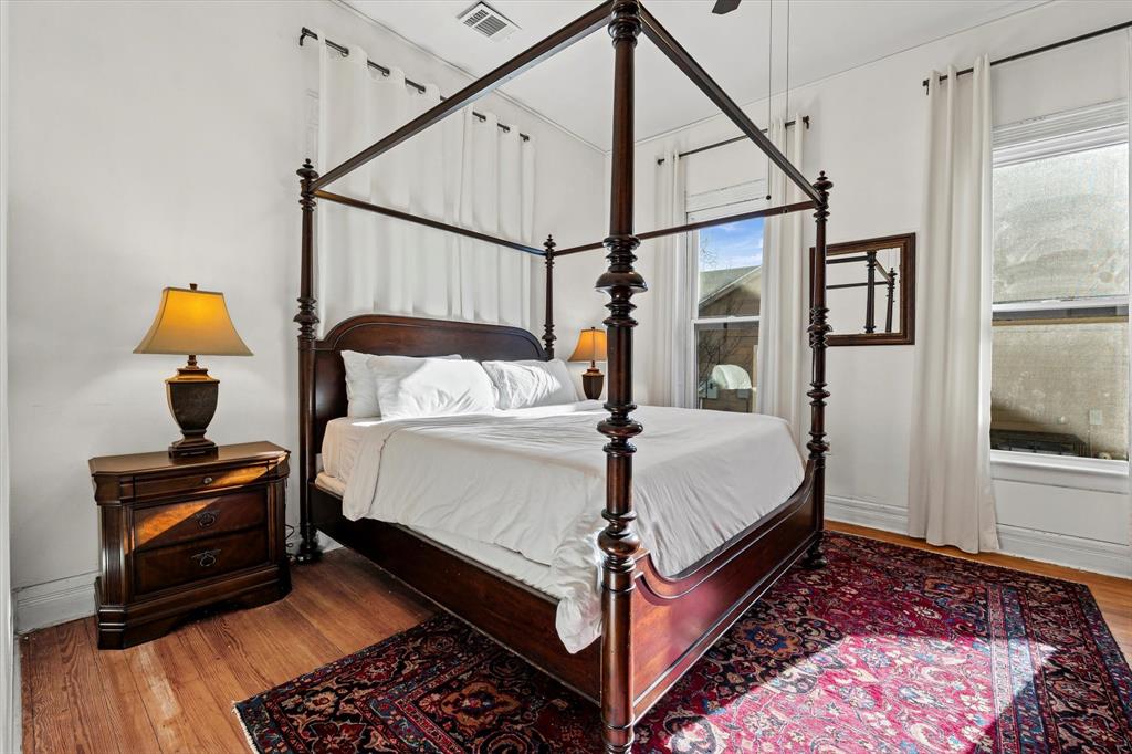 1618 North 6th Street Waco, TX 76707 - Photo 22 of 36 a bed sitting in a bedroom next to a window