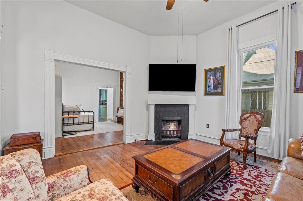 1618 North 6th Street Waco, TX 76707 - Photo 7 of 36 a living room with furniture a flat screen tv and a fireplace