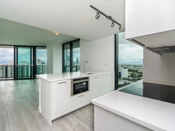 a kitchen that has a stove and a microwave