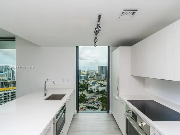 a kitchen with a sink and cabinets