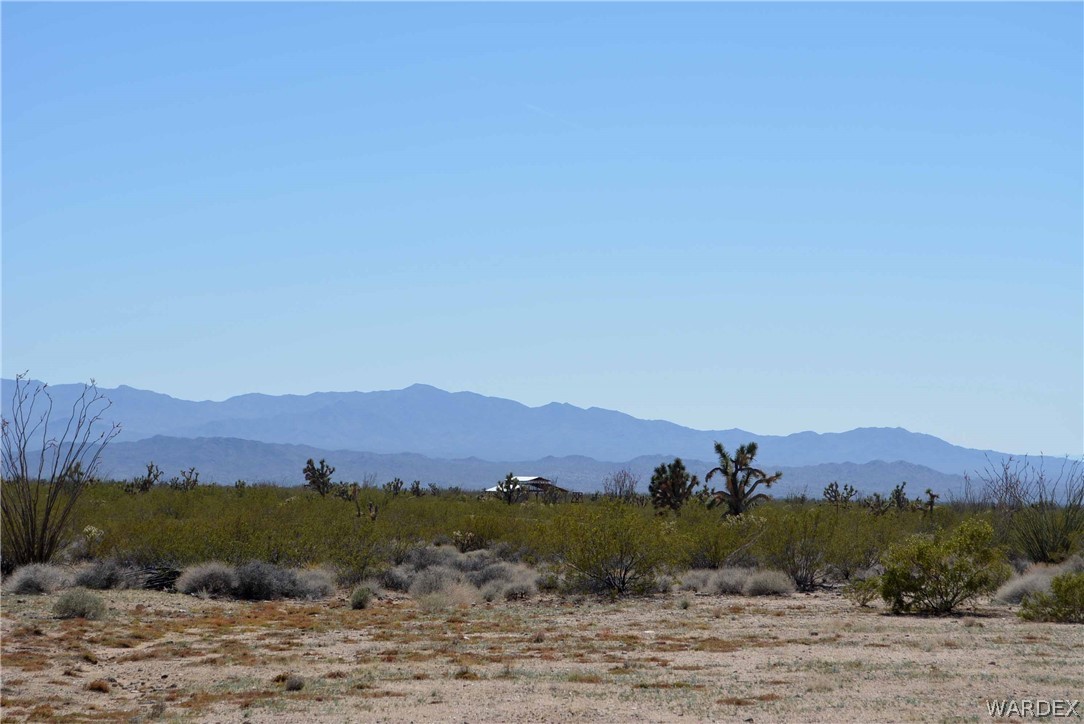Lot 3398 Santa Fe Ranch Road Yucca, AZ 86438 - Photo 3 of 9 a view of a lush green hillside and a houses