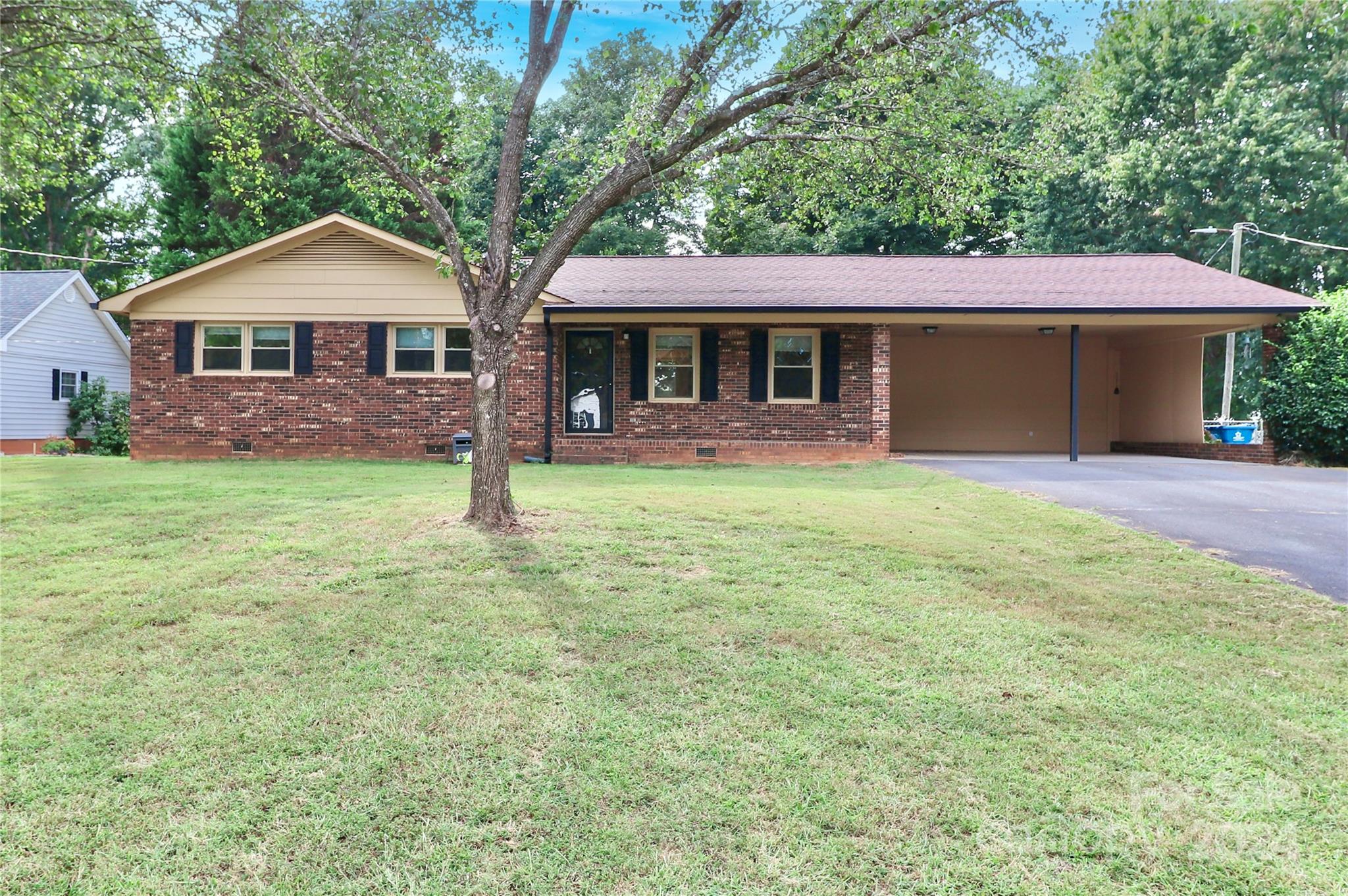 a front view of a house with yard and green space