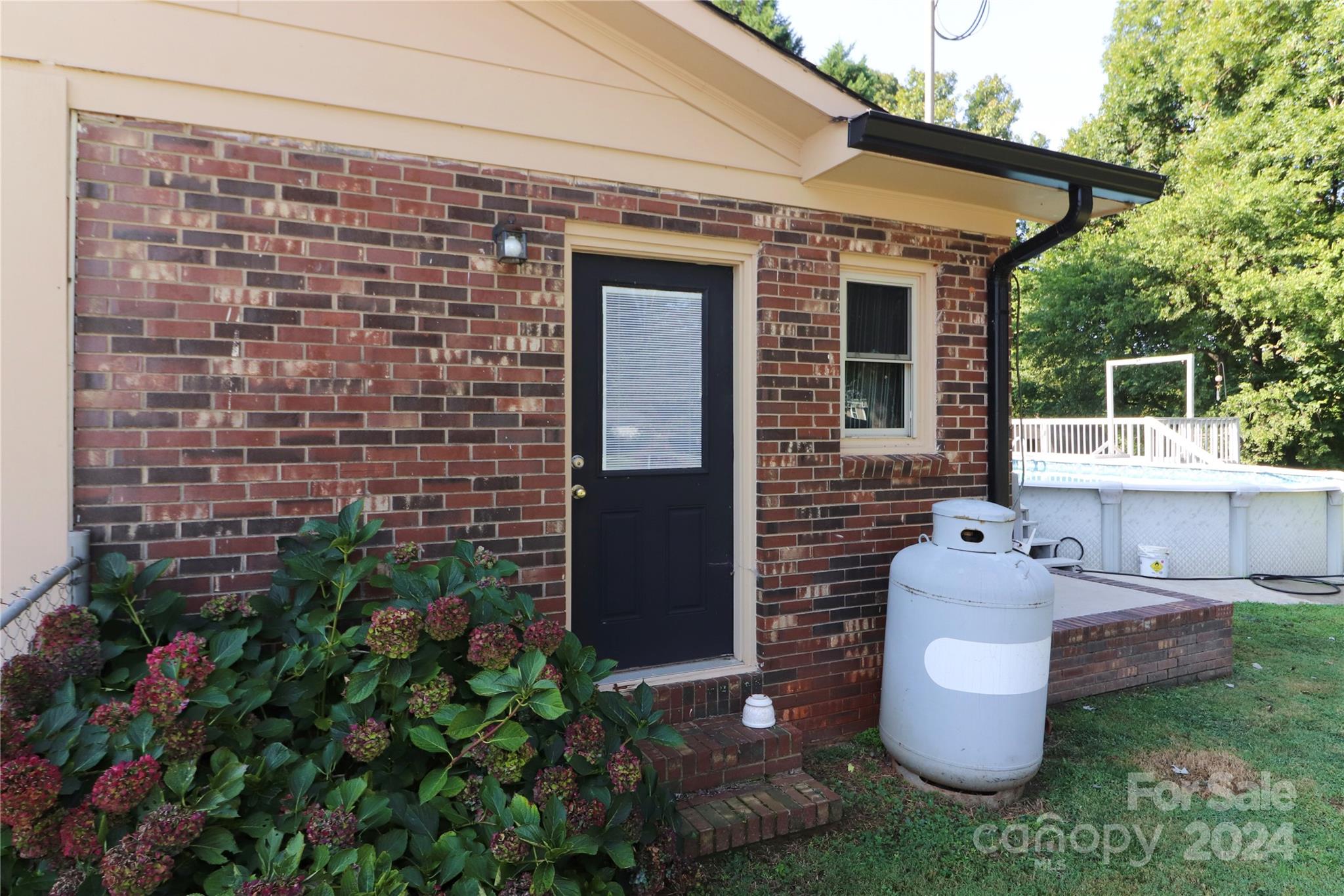 168 Mooreland Road Mooresville, NC 28117 - Photo 21 of 31 a brick house with potted plants in front of it