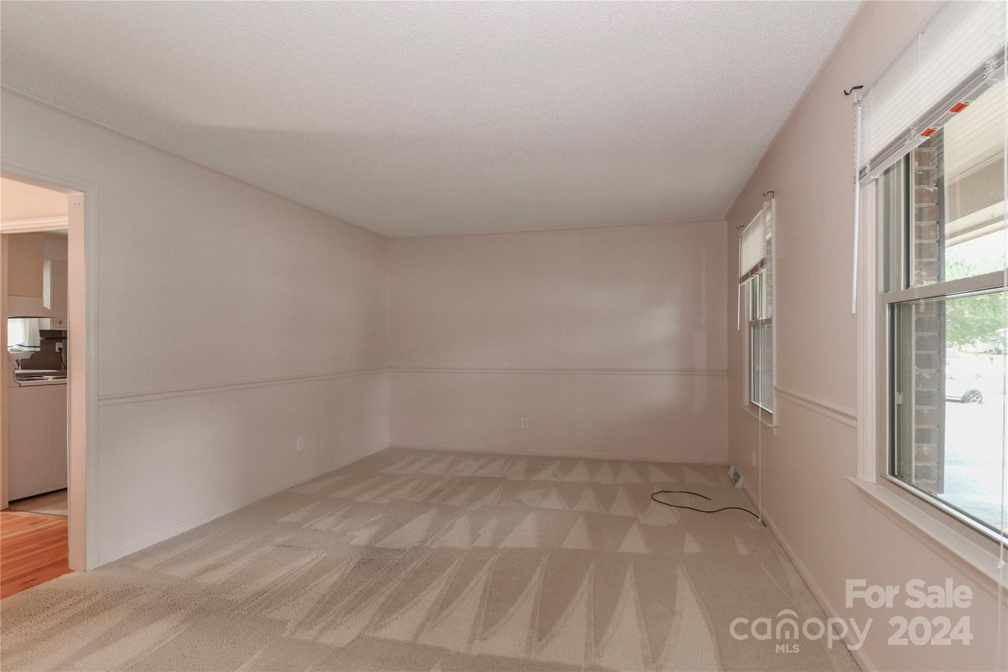 168 Mooreland Road Mooresville, NC 28117 - Photo 3 of 31 wooden floor in an empty room with a window