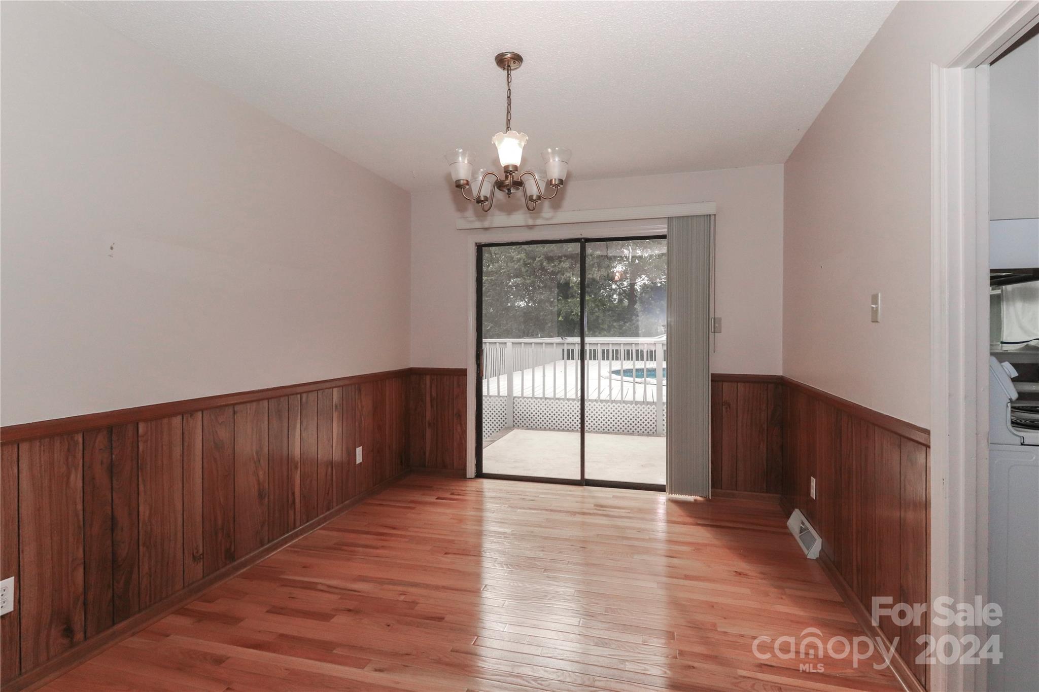 168 Mooreland Road Mooresville, NC 28117 - Photo 7 of 31 a view of an empty room with wooden floor and a window