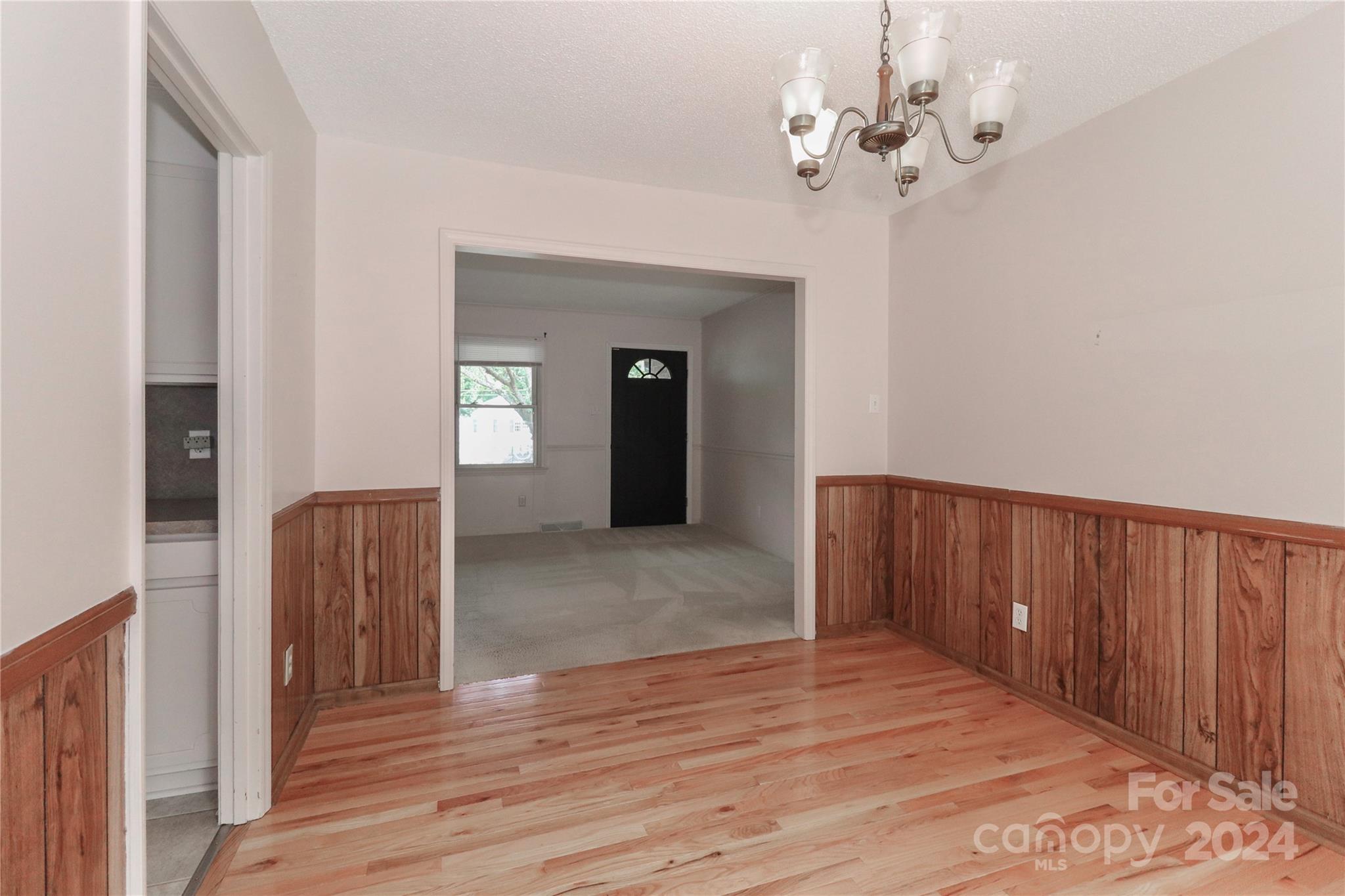 168 Mooreland Road Mooresville, NC 28117 - Photo 8 of 31 a view of a livingroom with wooden floor and a chandelier