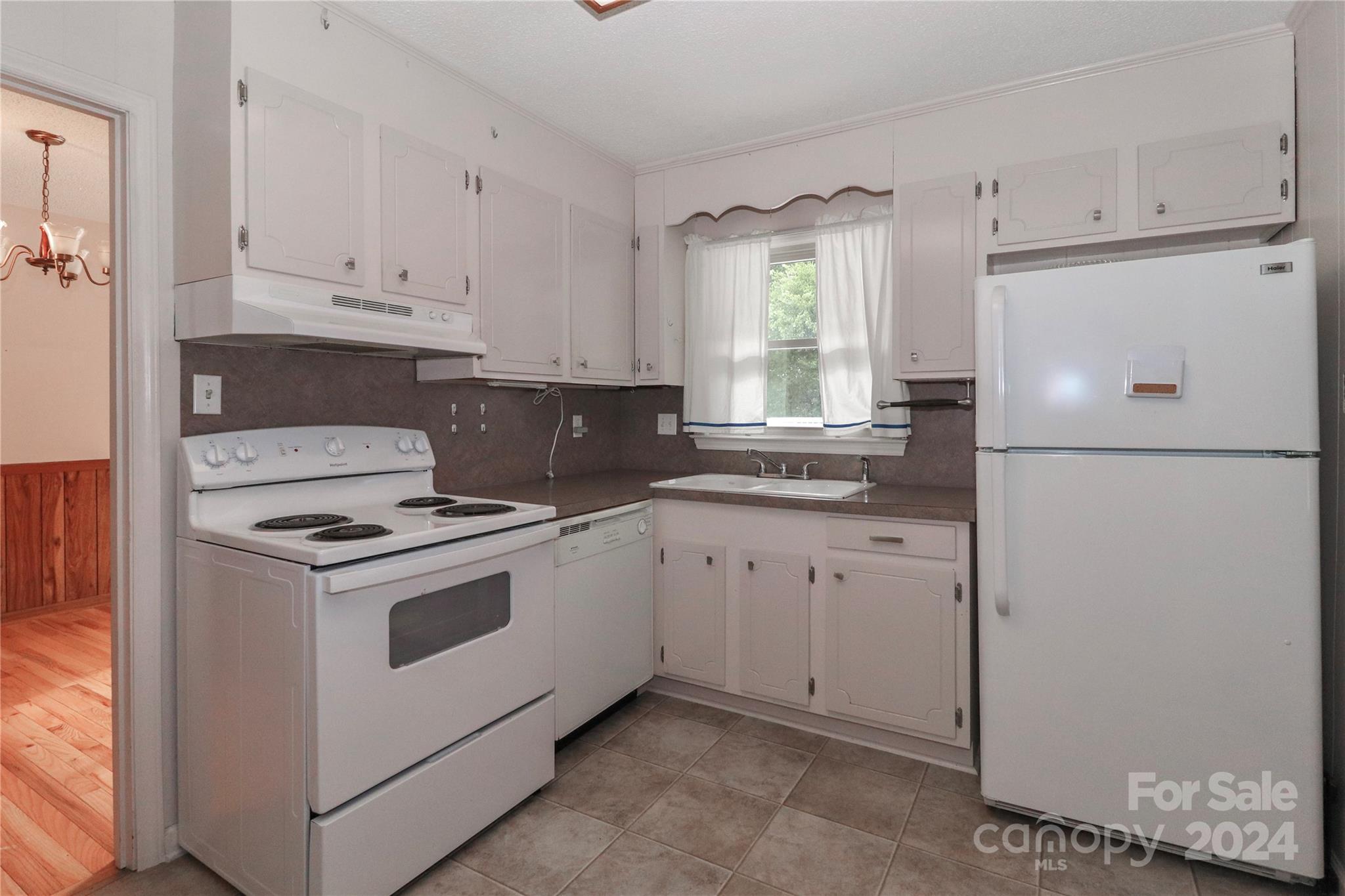 168 Mooreland Road Mooresville, NC 28117 - Photo 10 of 31 a kitchen with cabinets appliances a sink and a window