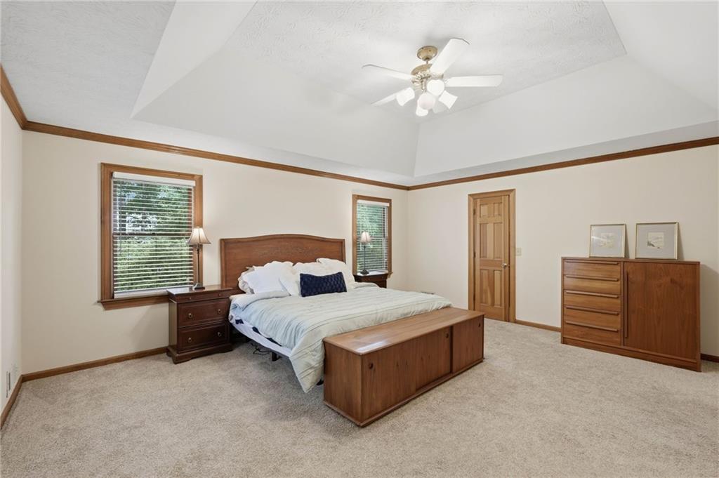 4891 Bill Cheek Road Auburn, GA 30011 - Photo 29 of 99 a bedroom with a large bed and chandelier