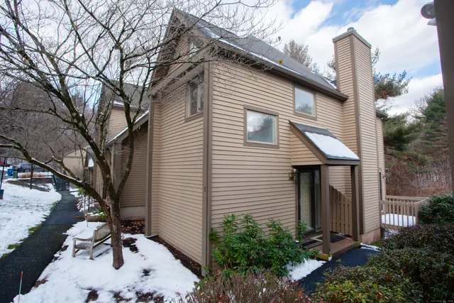 a backyard of a house with plants and trees