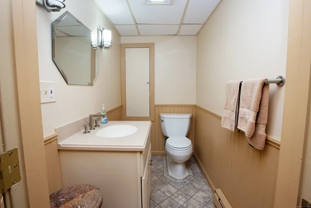 a bathroom with a sink toilet and mirror