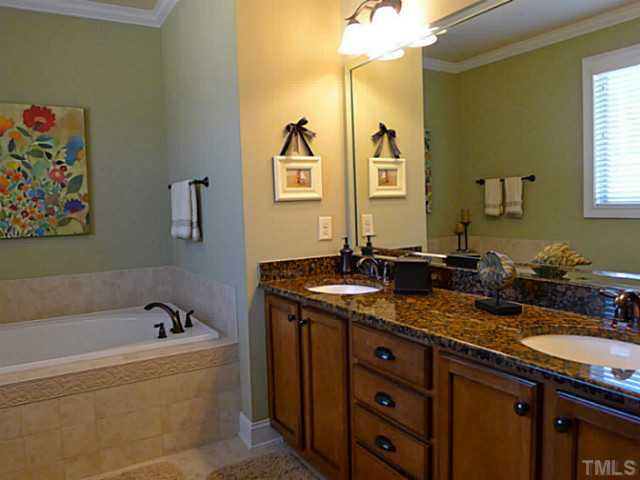 9811 Carvel Court Raleigh, NC 27613 - Photo 15 of 25 The master bath offers the perfect place to unwind! With it's garden tub, oversized tile shower, dual sinks, and granite countertops, this may be your favorite room in the house! Master Bath/Spa