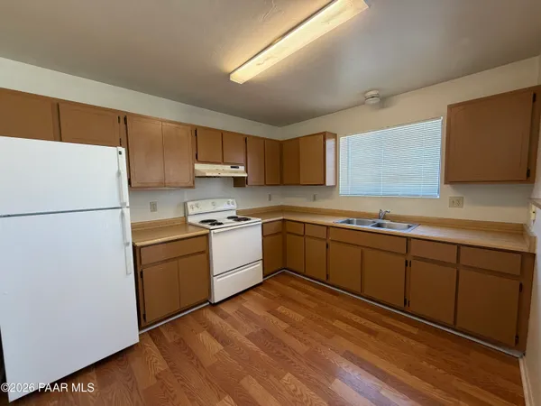 a kitchen with sink a microwave and refrigerator