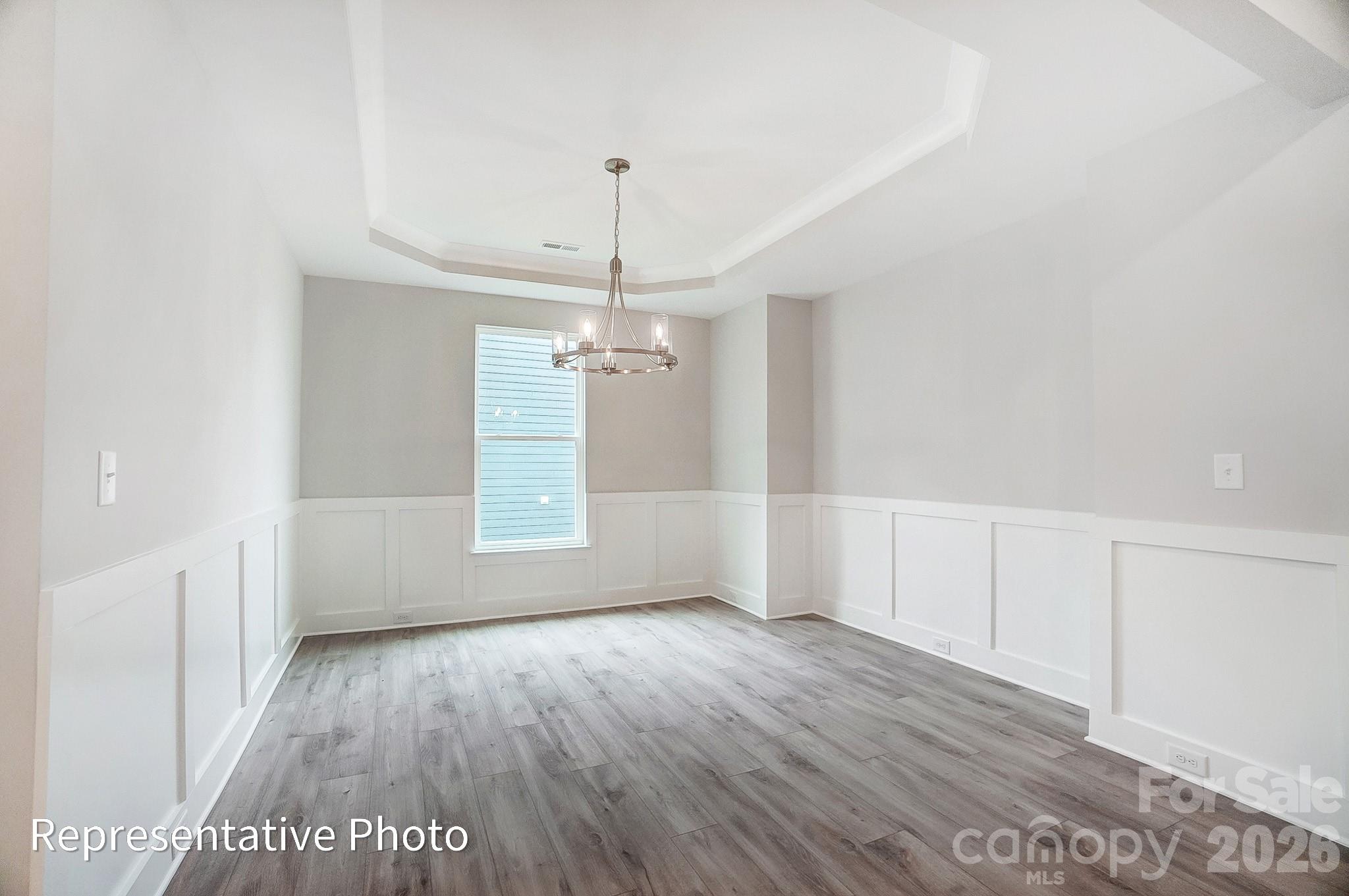 2019 Mantle Rdg Drive Indian Trail, NC 28079 - Photo 14 of 41 an empty room with wooden floor and windows