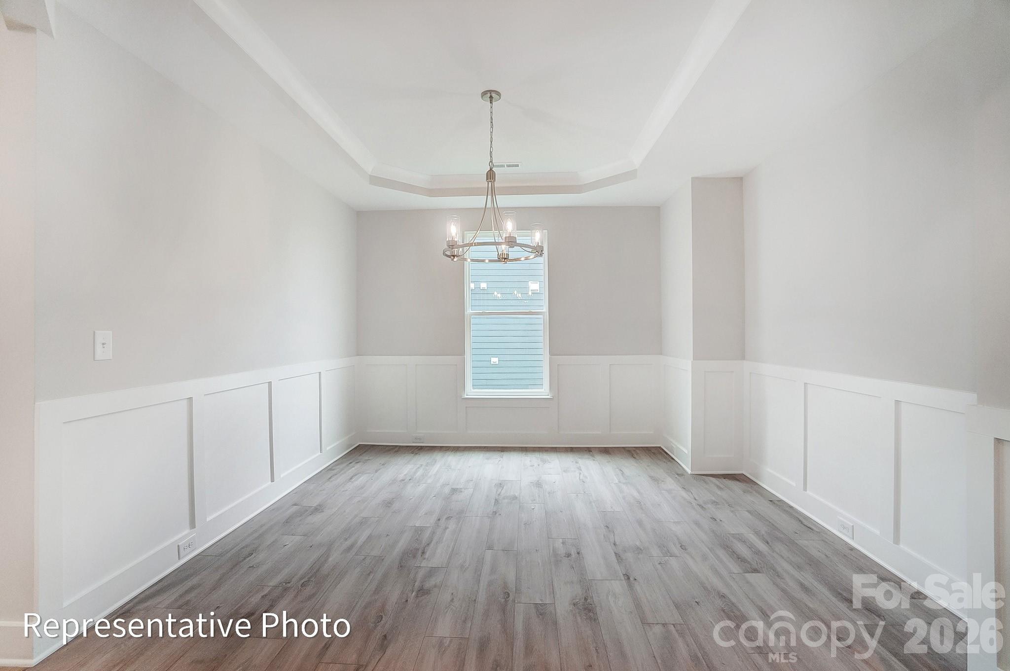 2019 Mantle Rdg Drive Indian Trail, NC 28079 - Photo 15 of 41 a view of an empty room with window and wooden floor