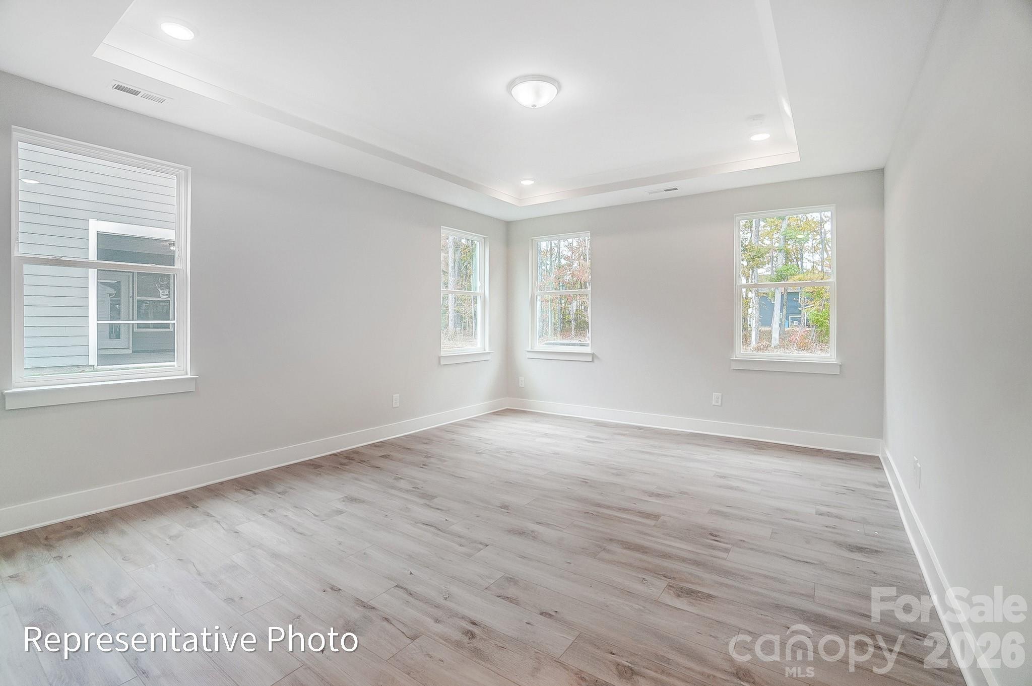 2019 Mantle Rdg Drive Indian Trail, NC 28079 - Photo 19 of 41 an empty room with wooden floor and windows