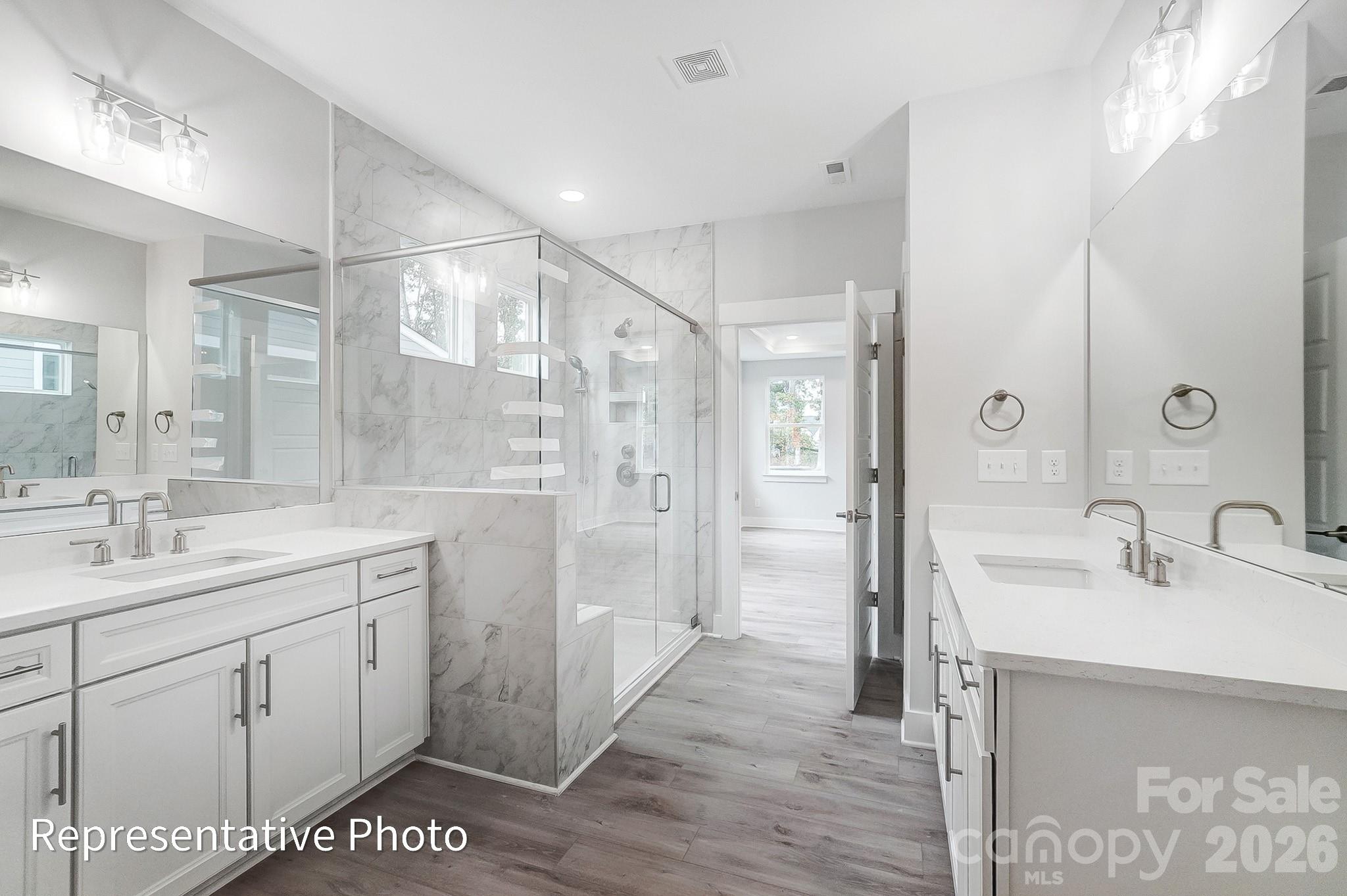 2019 Mantle Rdg Drive Indian Trail, NC 28079 - Photo 20 of 41 a spacious bathroom with a shower sink and mirror