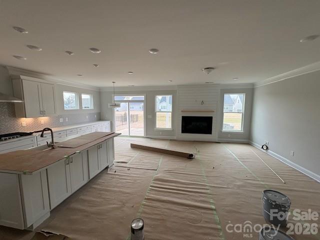 2019 Mantle Rdg Drive Indian Trail, NC 28079 - Photo 4 of 41 a large white kitchen with granite countertop a sink and dishwasher a stove top oven with wooden floor