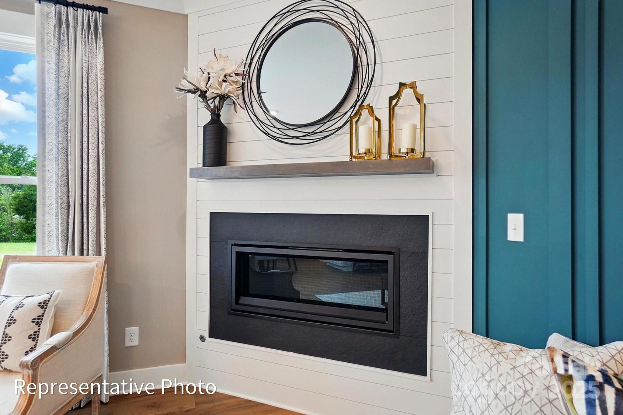 2019 Mantle Rdg Drive Indian Trail, NC 28079 - Photo 6 of 27 a living room with a fireplace and a window