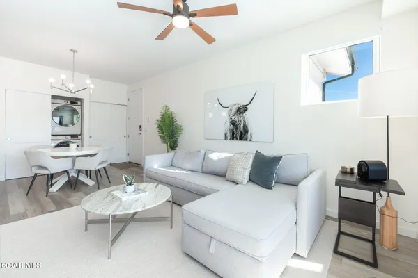 a dining room with furniture and wooden floor