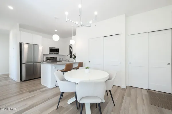 a kitchen with stainless steel appliances granite countertop a refrigerator and a stove top oven