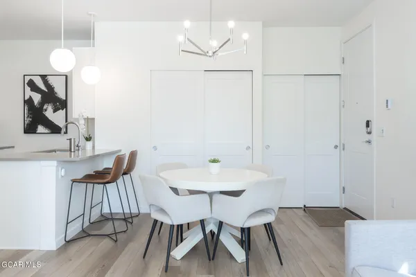 a kitchen with stainless steel appliances a refrigerator a stove a microwave and a sink